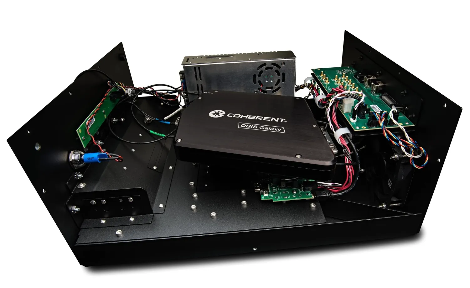 Open electronic device housing with a central black Coherent OBIS Galaxy module, connected circuit boards, and wiring inside a metal frame.
