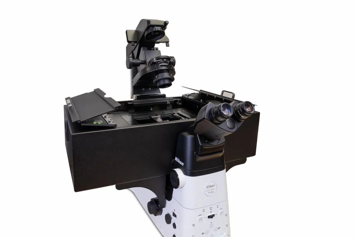 Nikon Ti2 inverted research microscope with binocular eyepieces and black stage area.