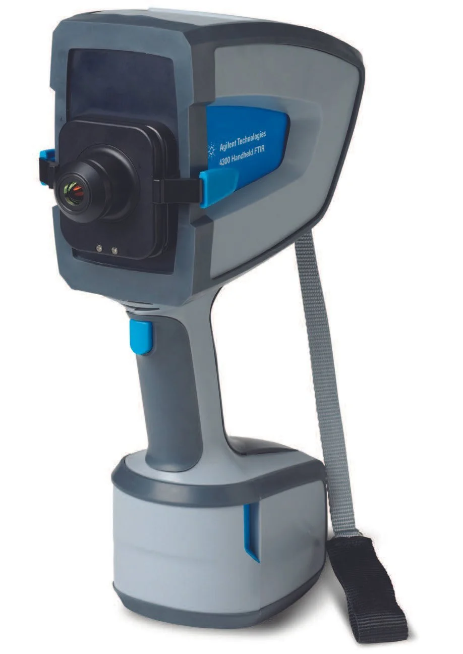 Agilent Technologies 4300 Handheld FTIR scientific instrumentation device with a handle and strap.