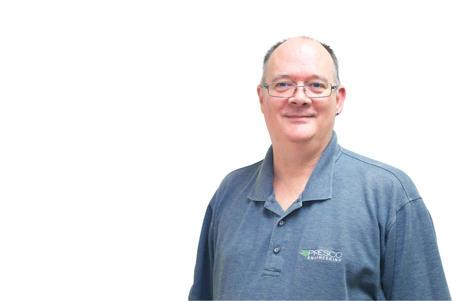 Smiling middle-aged man wearing glasses and a blue polo shirt with Presco Engineering logo on a white background.
