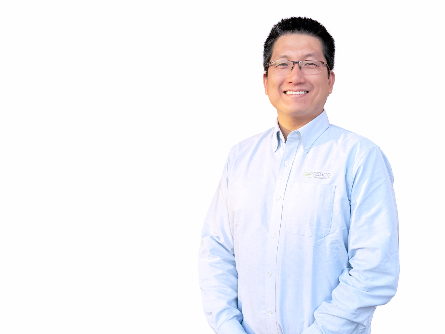 Smiling man with glasses wearing a light blue button-up shirt with Presco Engineering logo on a white background.