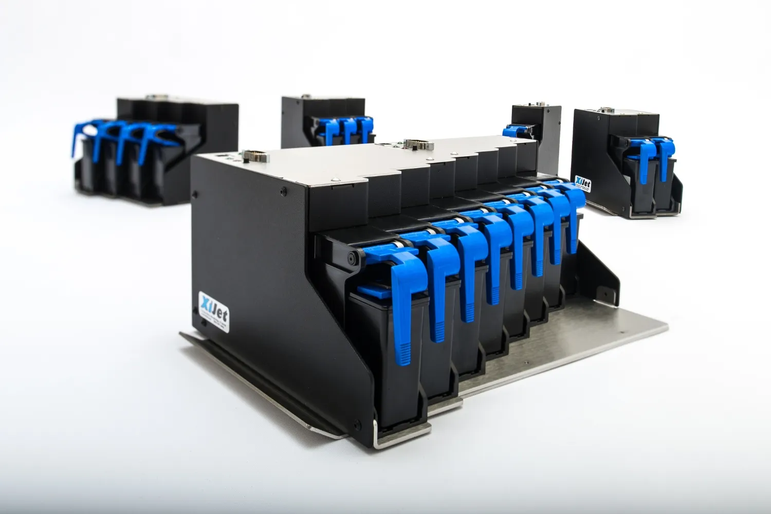 Black and blue XiJet industrial printing modules arranged on a white surface.