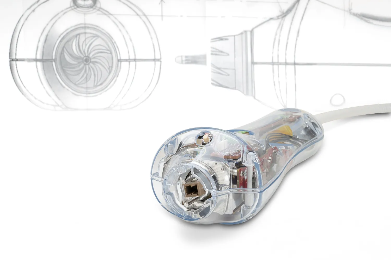 Transparent electronic device with visible circuit components connected to a white cable on a white background.