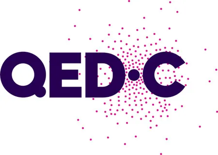 Logo with bold letters QED•C accompanied by a pattern of magenta dots radiating outward behind the C.