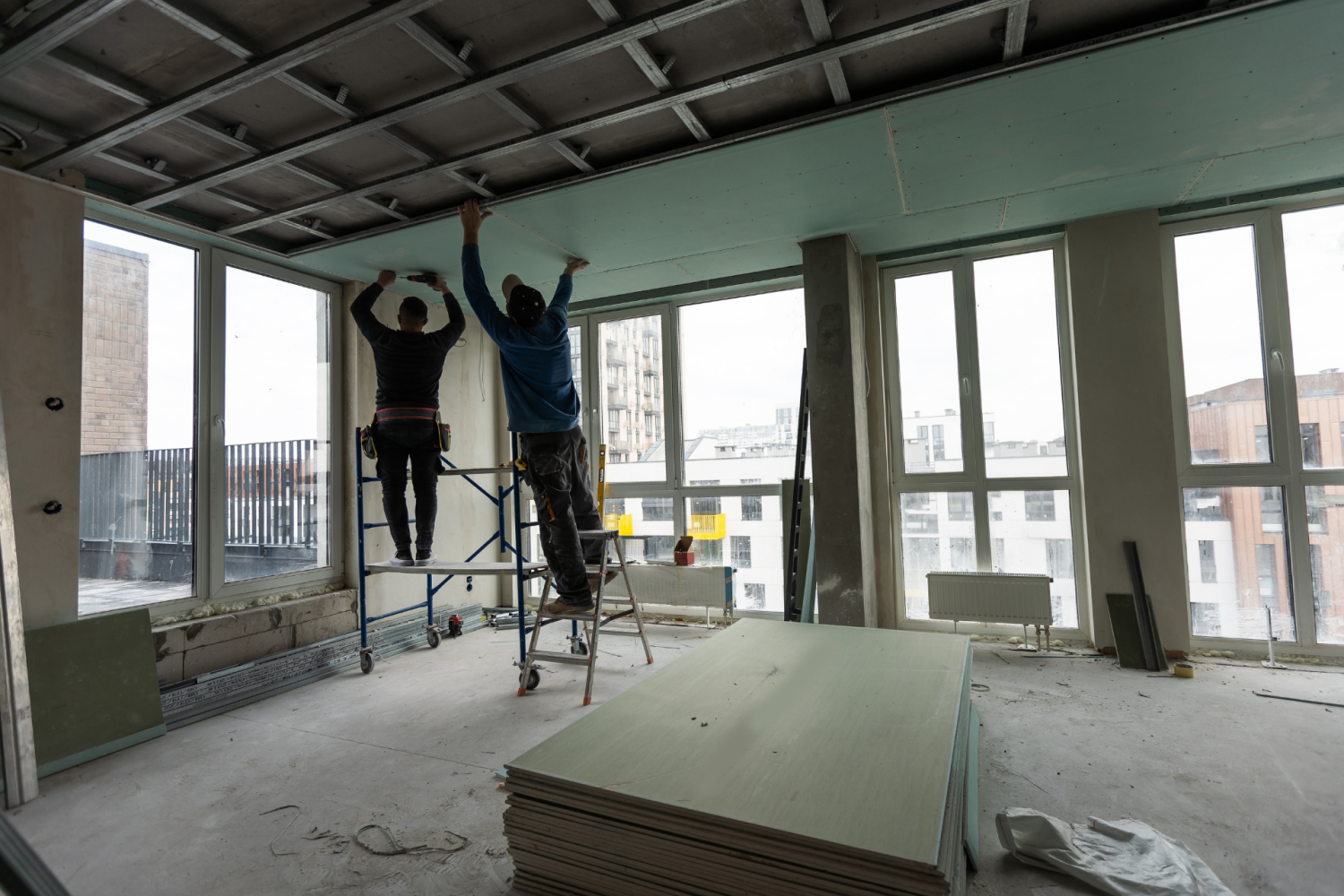 Construction workers completing the ceiling on an office building renovation