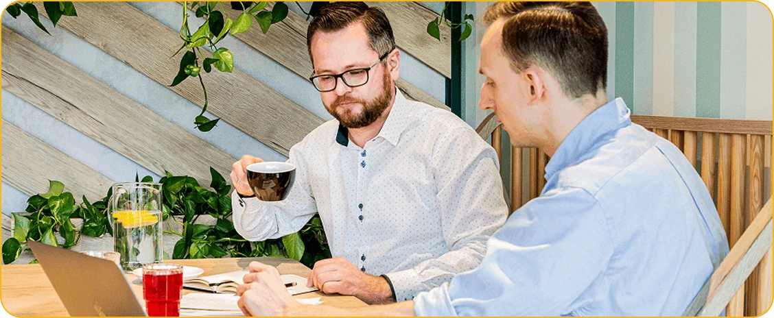 two men in a restaurant discussing business matters