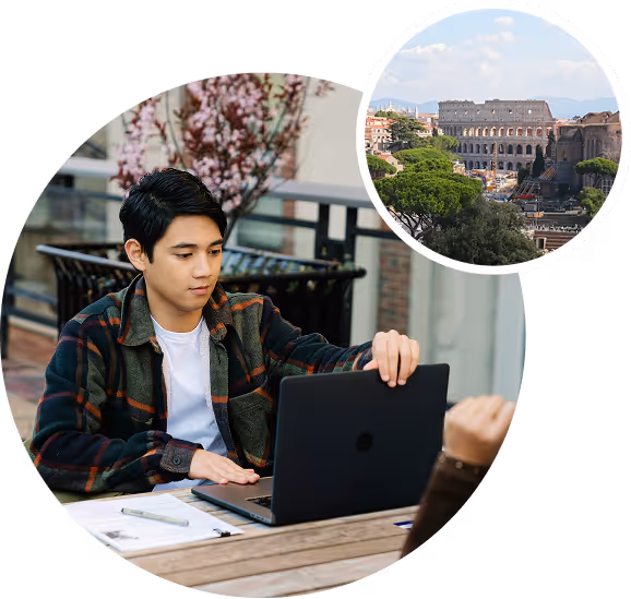 Young man sitting outdoors using a laptop with a small circular inset showing the Colosseum in Rome.