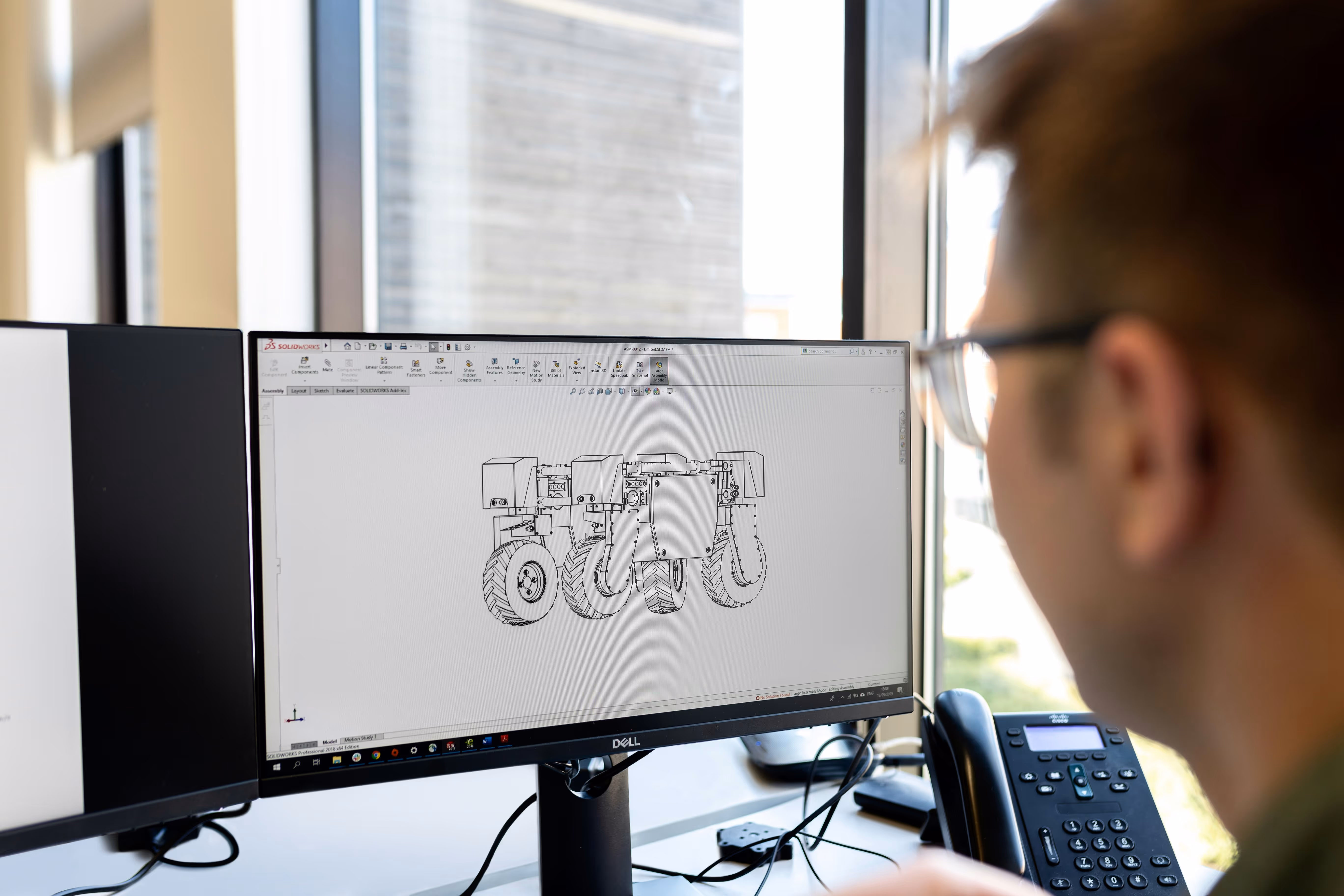 Engineer working on CAD software creating technical designs in an engineering environment