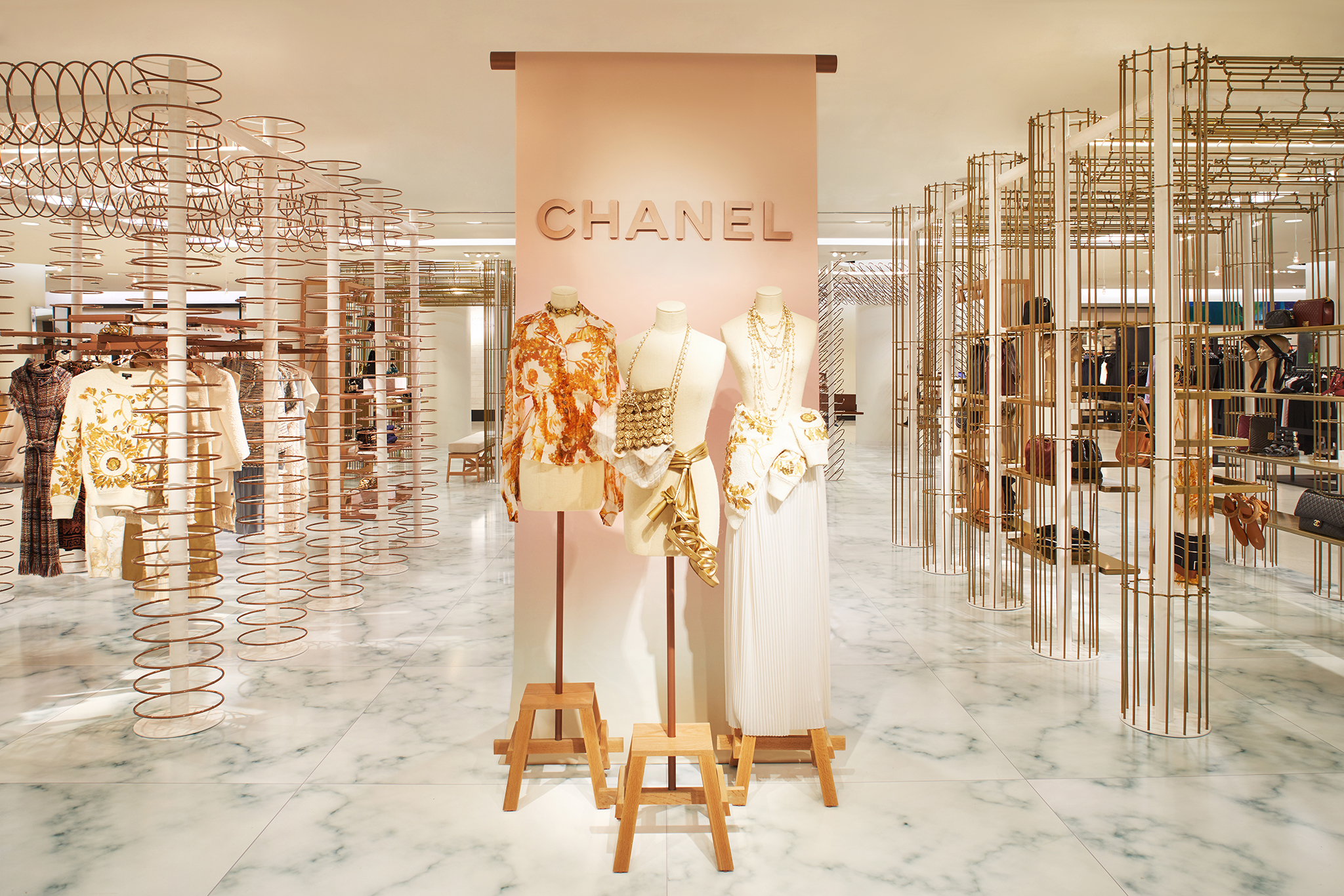 A store installation for Chanel, featuring custom brass fixtures and marble flooring.