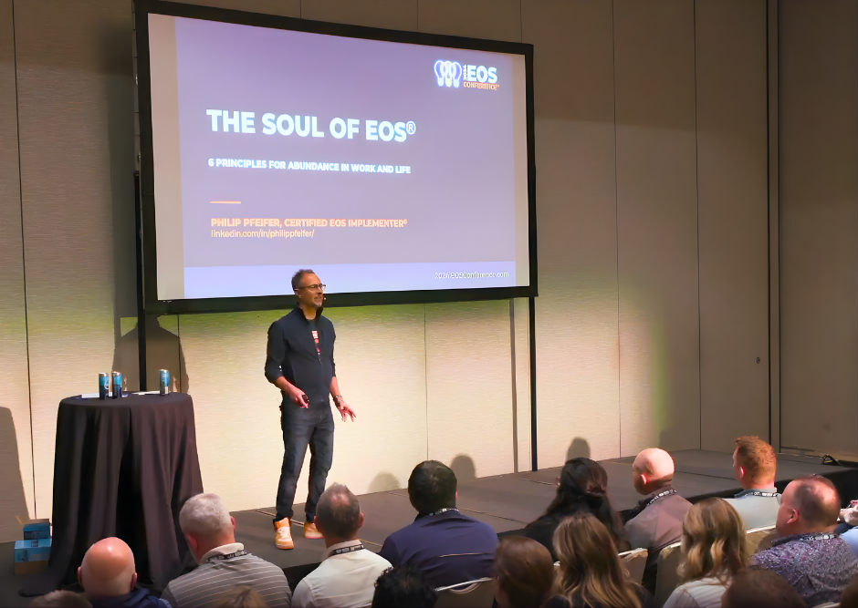 Speaker Philip Pfeifer presenting 'The Soul of EOS' at a conference with audience seated in front.