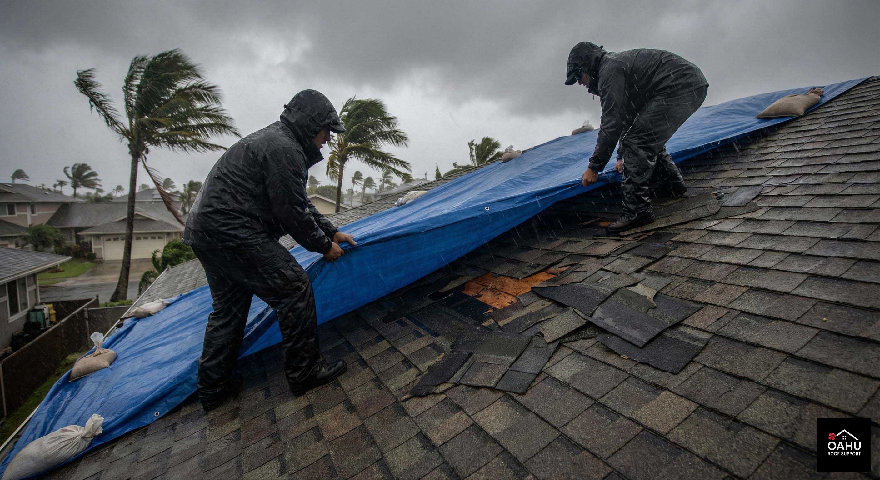 Emergency roof tarp being installed on a storm-damaged Oahu home