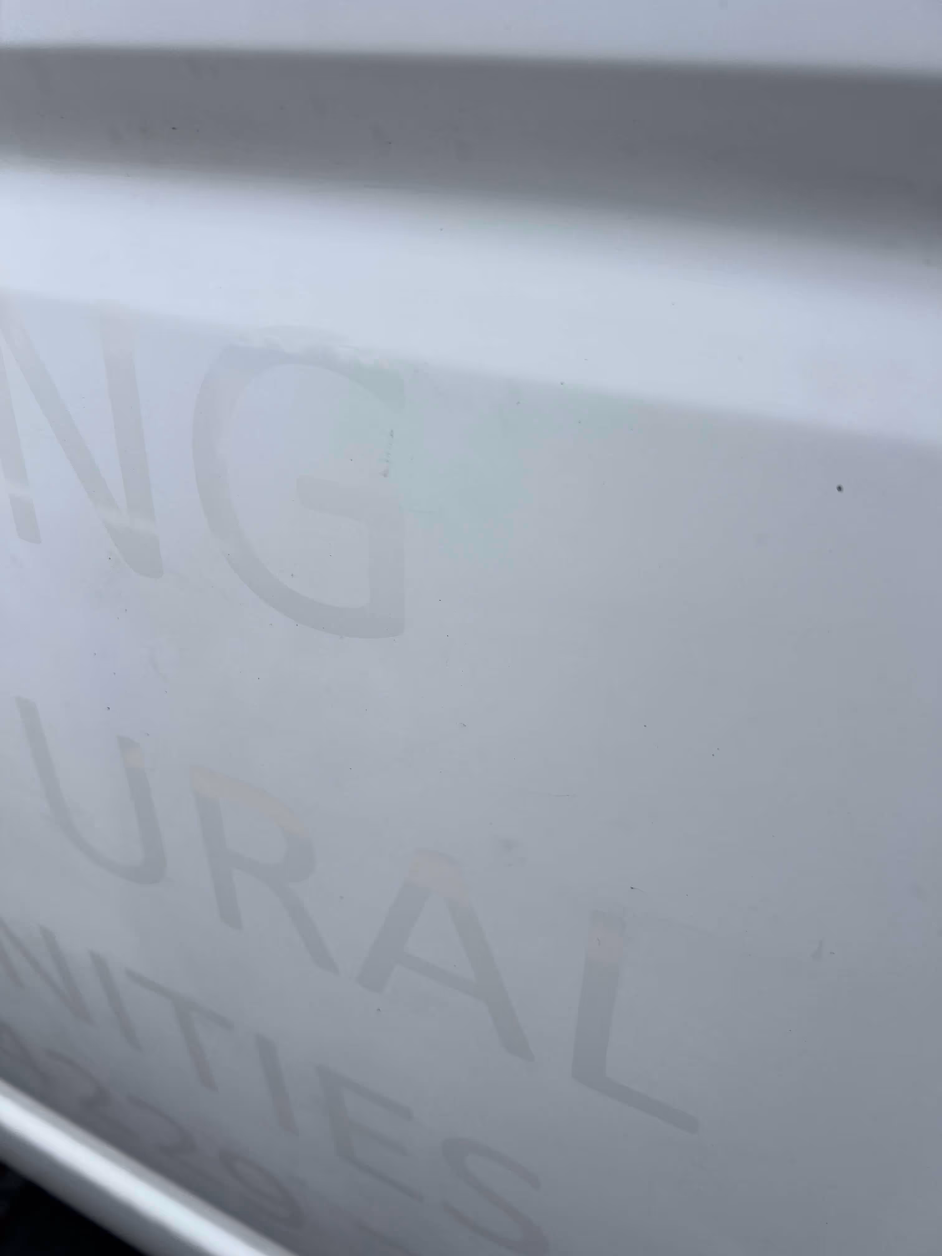 Exterior paintwork with decal signage masking on paintwork following removal of the signage but prior to cleaning 