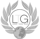 Luxury Travel Guide logo with LG initials, laurel wreath, and globe icon.