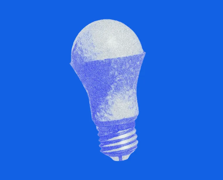 Pointillism-style illustration of a light bulb with a blue background.