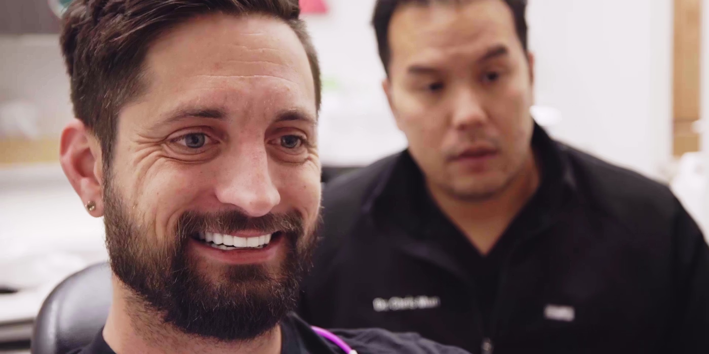 Man smiling confidently after dental treatment and smile makeover from the best cosmetic dentist in Pflugerville.