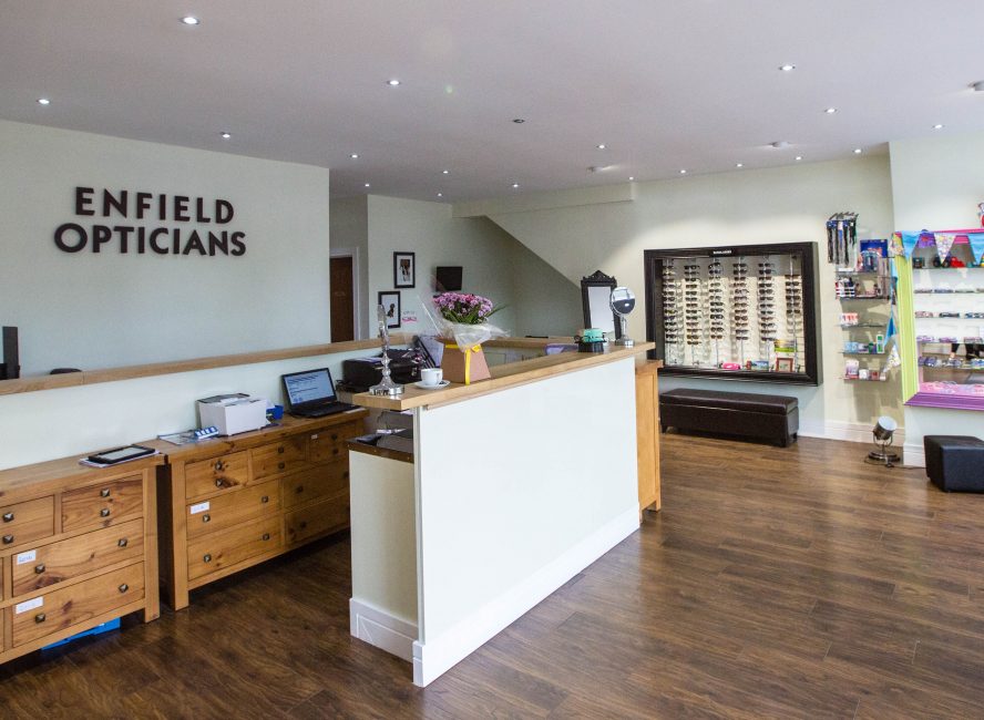 Interior of Enfield Opticians with reception desk and eyeglass display