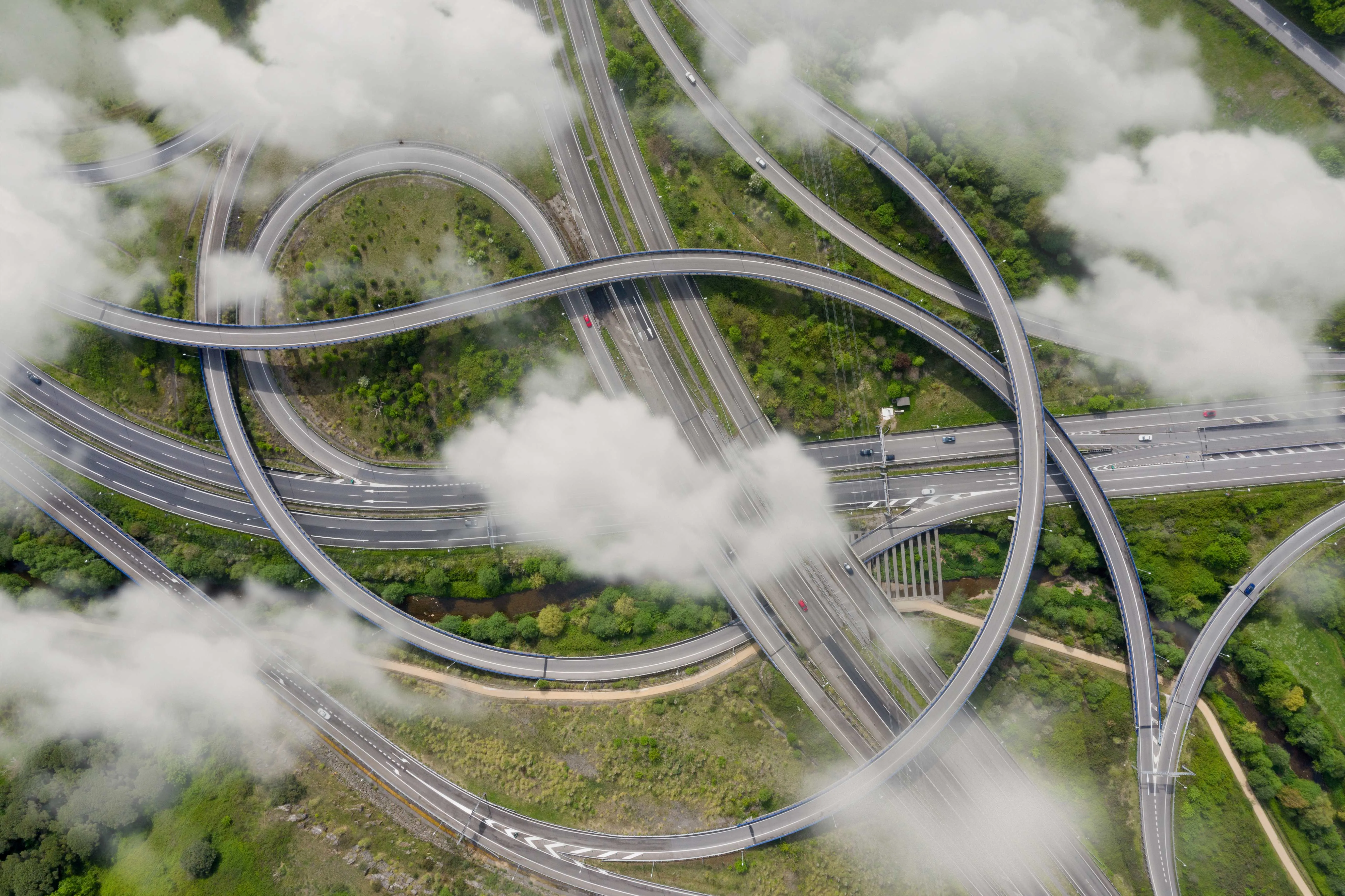 Clouds drifting over curving urban streets