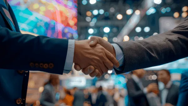 Two people shaking hands during a business exchange
