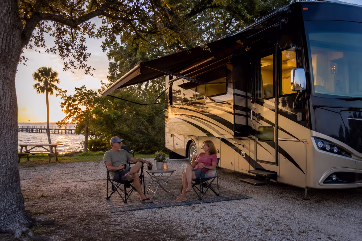 Couple relaxing outside a luxury RV near Tampa