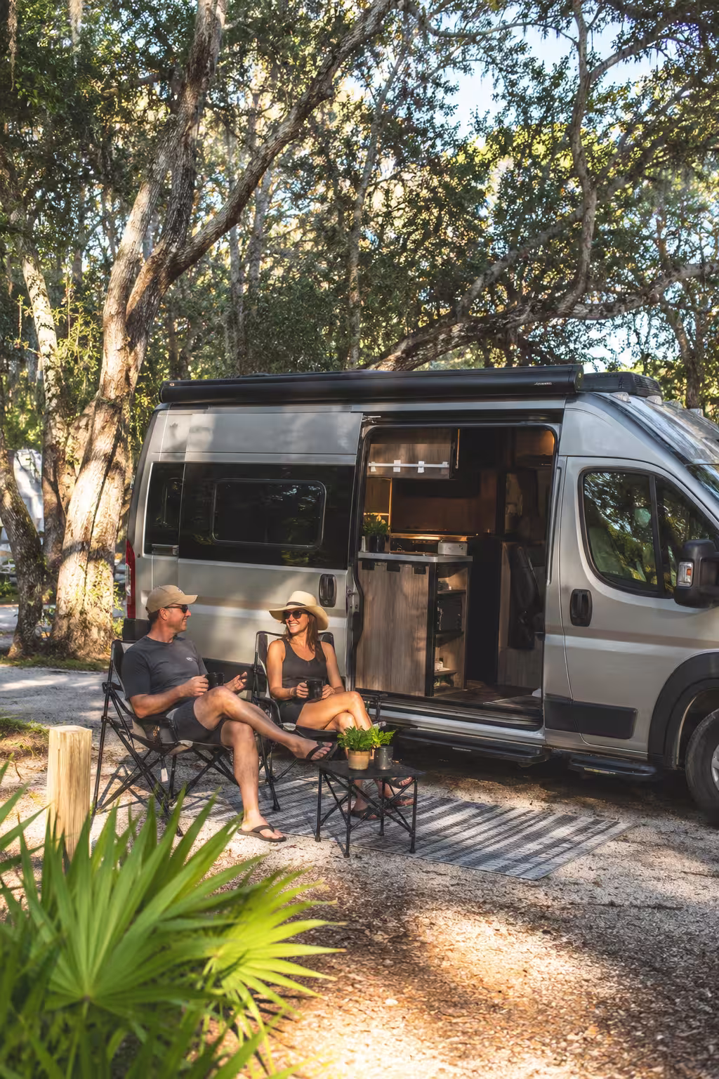 Couple beside a camper van at a Tampa RV park