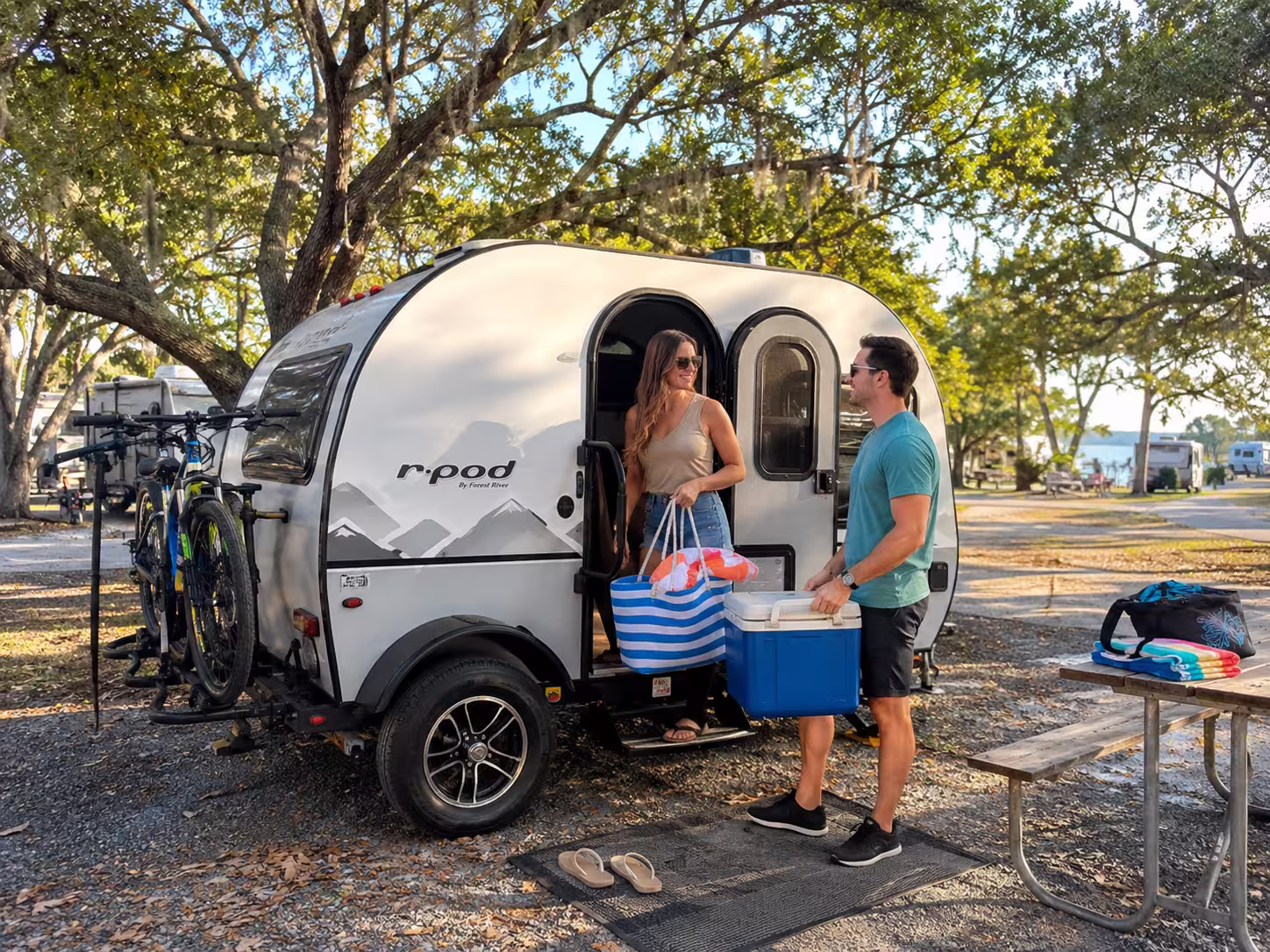 Couple loading beach gear into a camper at a Tampa RV park