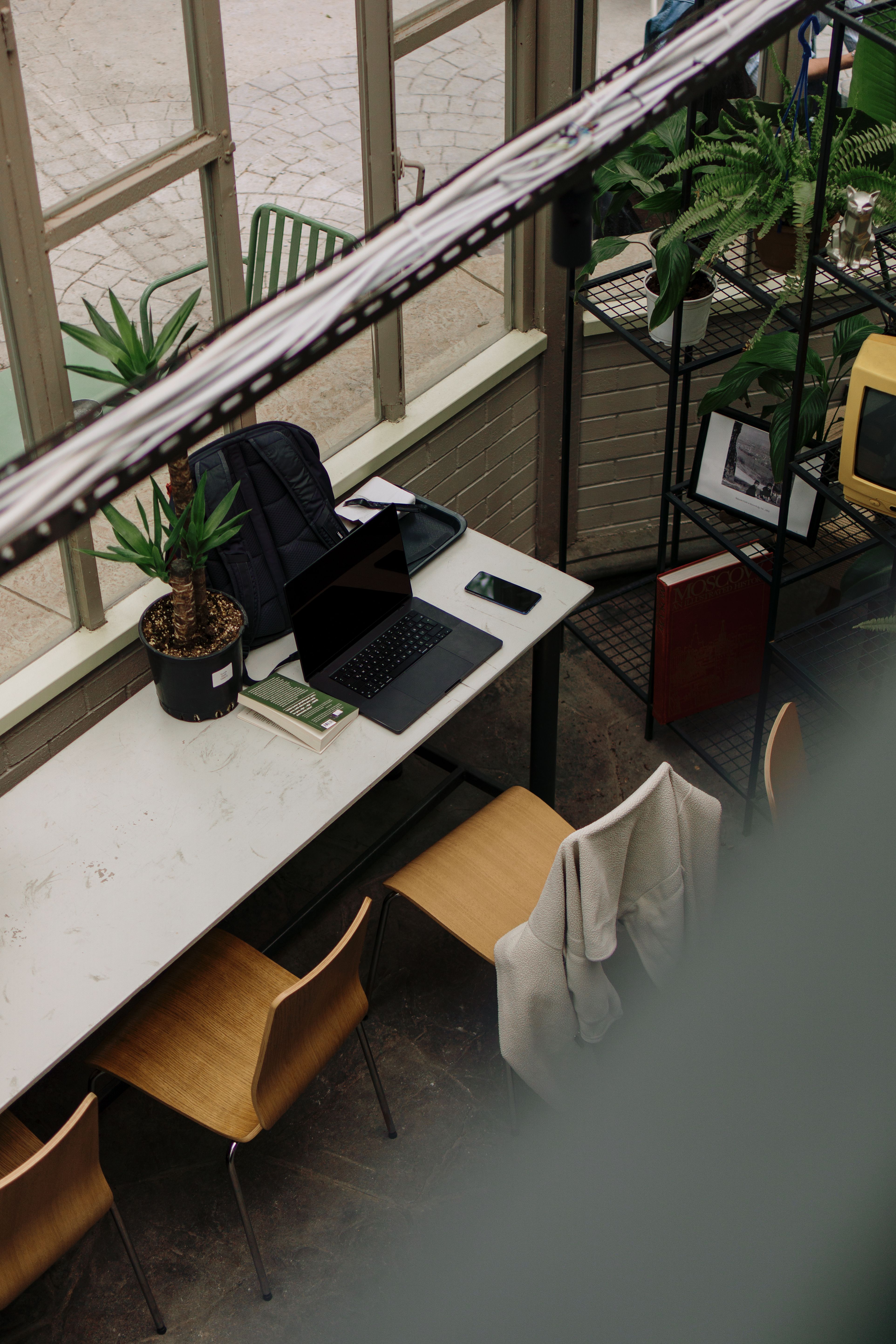 Restaurant and hospitality business interior with communal tables and natural light.