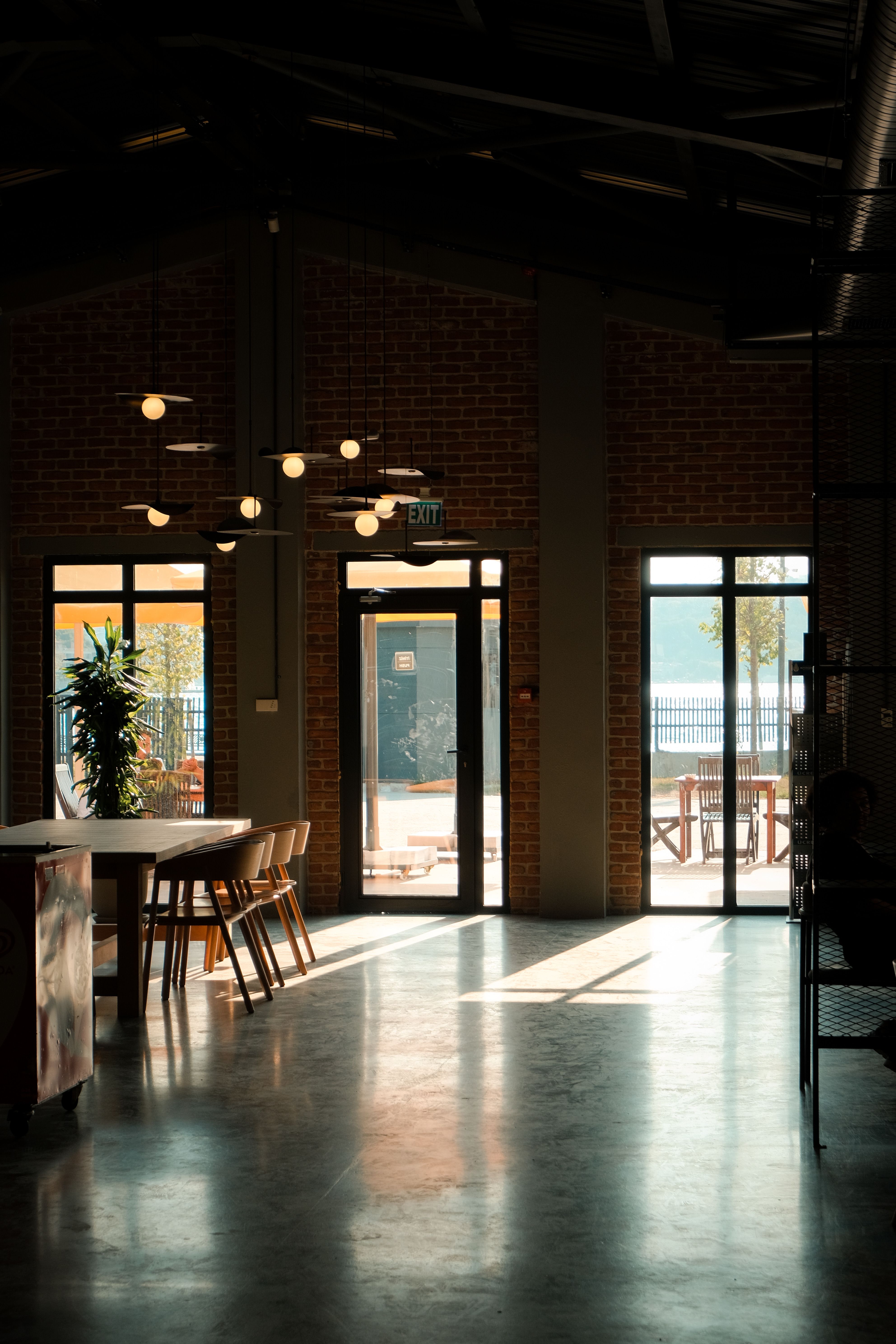 Restaurant and hospitality business interior with communal tables and natural light.