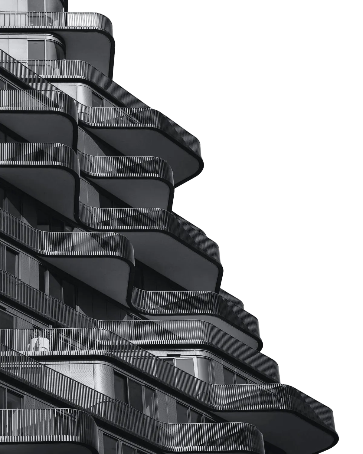Black and white photo of a modern building with curved balconies and metal railings.