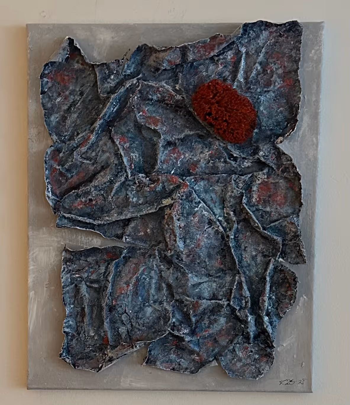 Abstract textured painting with crumpled dark blue and gray shapes and a red circular area on a light gray background.