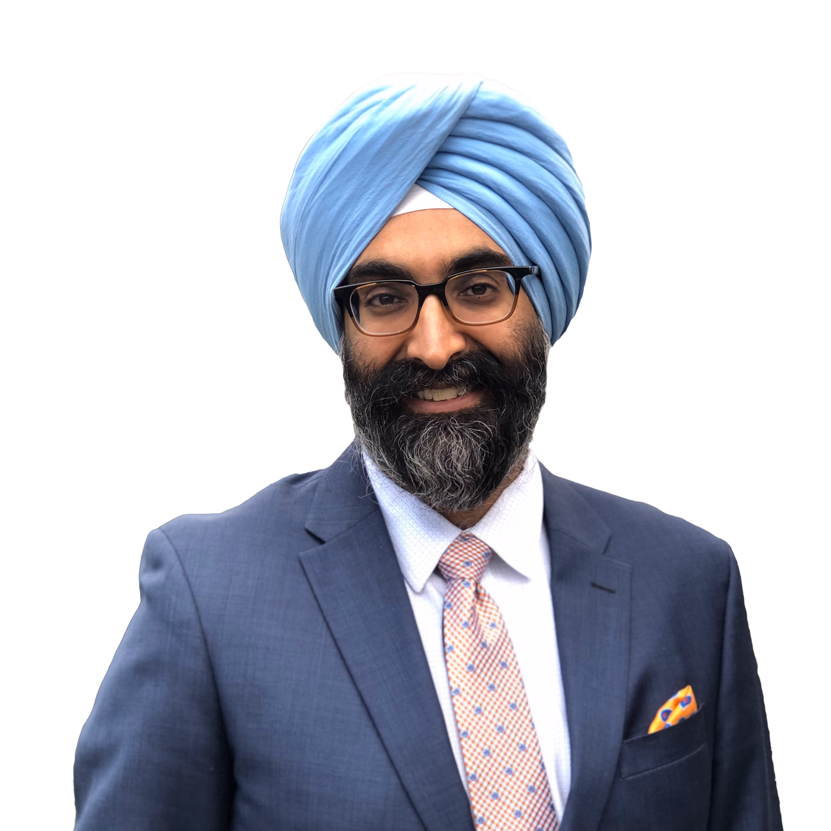 Man wearing glasses, a light blue turban, a blue suit, white shirt, and orange patterned tie with matching pocket square.