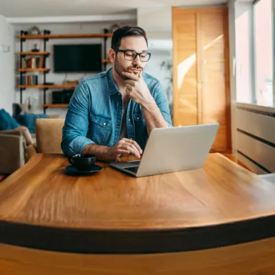 Homem verifica no notebook como medir a velocidade da internet.