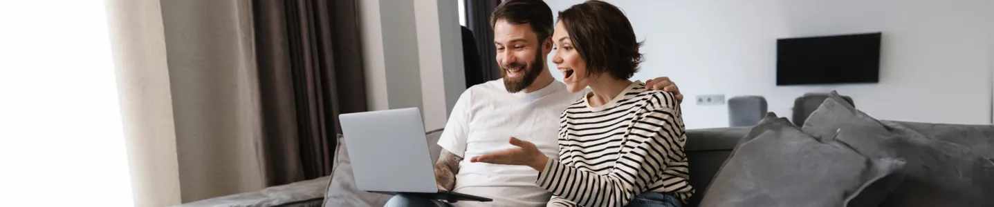 Casal comparando planos e escolhendo a melhor internet Oi Fibra pelo notebook.