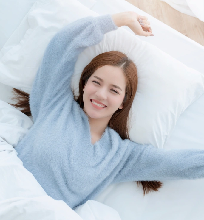 a young woman stretching on the bed, well rested