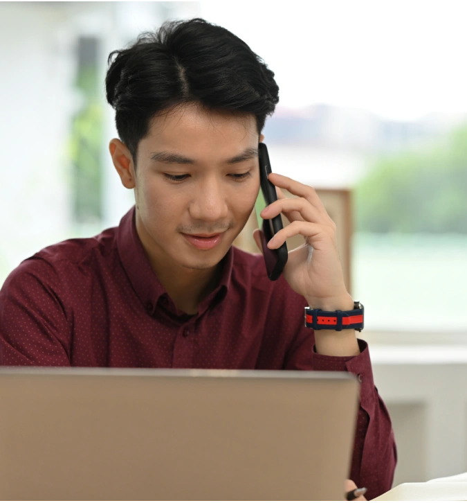 Asian men talking over mobile phone
