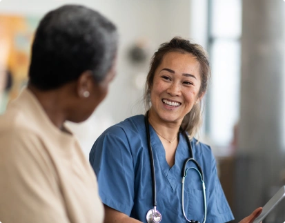 Two medical persons talking to each other and smiling