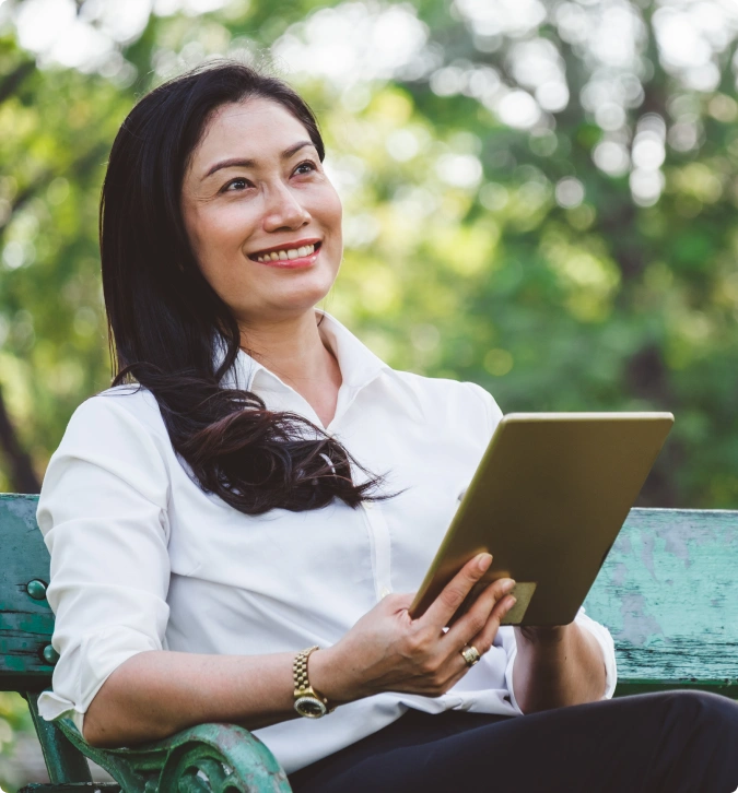 Woman in white shirt with tablet, smiling