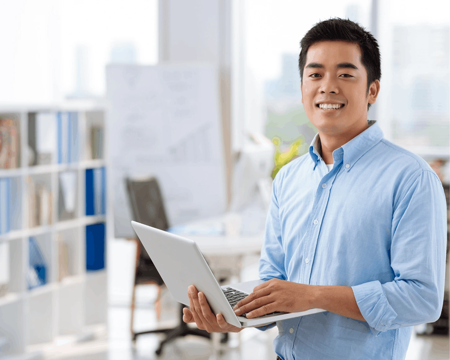 man in a shirt with a laptop