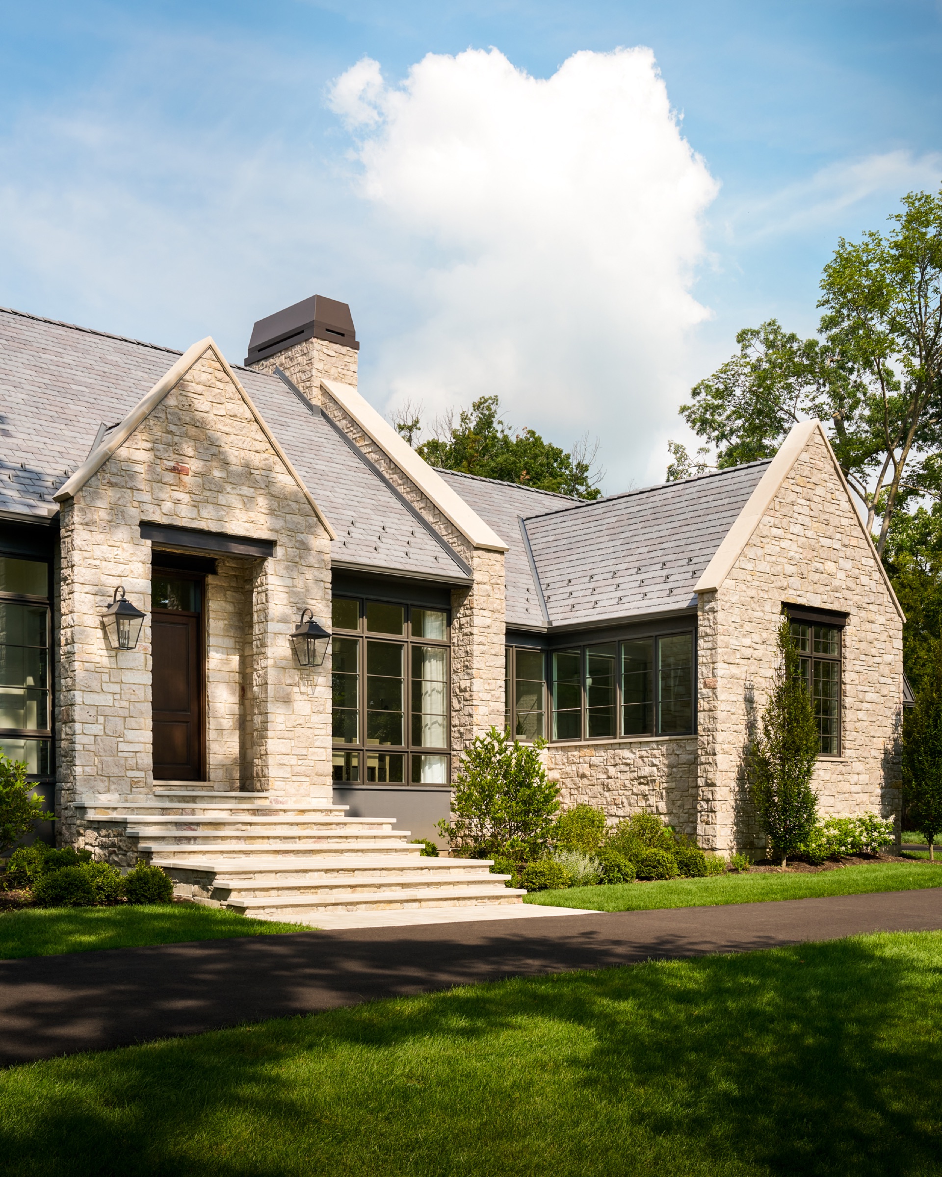 Front entry of an English cottage style home, custom designed and built by A. Perry Homes.