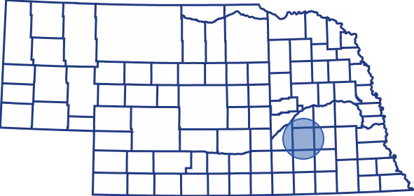 Outline map of Nebraska with county boundaries, highlighting a central-eastern county with a blue circle.