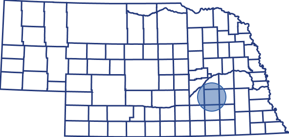 Outline map of Nebraska with county boundaries, highlighting a central-eastern county with a blue circle.