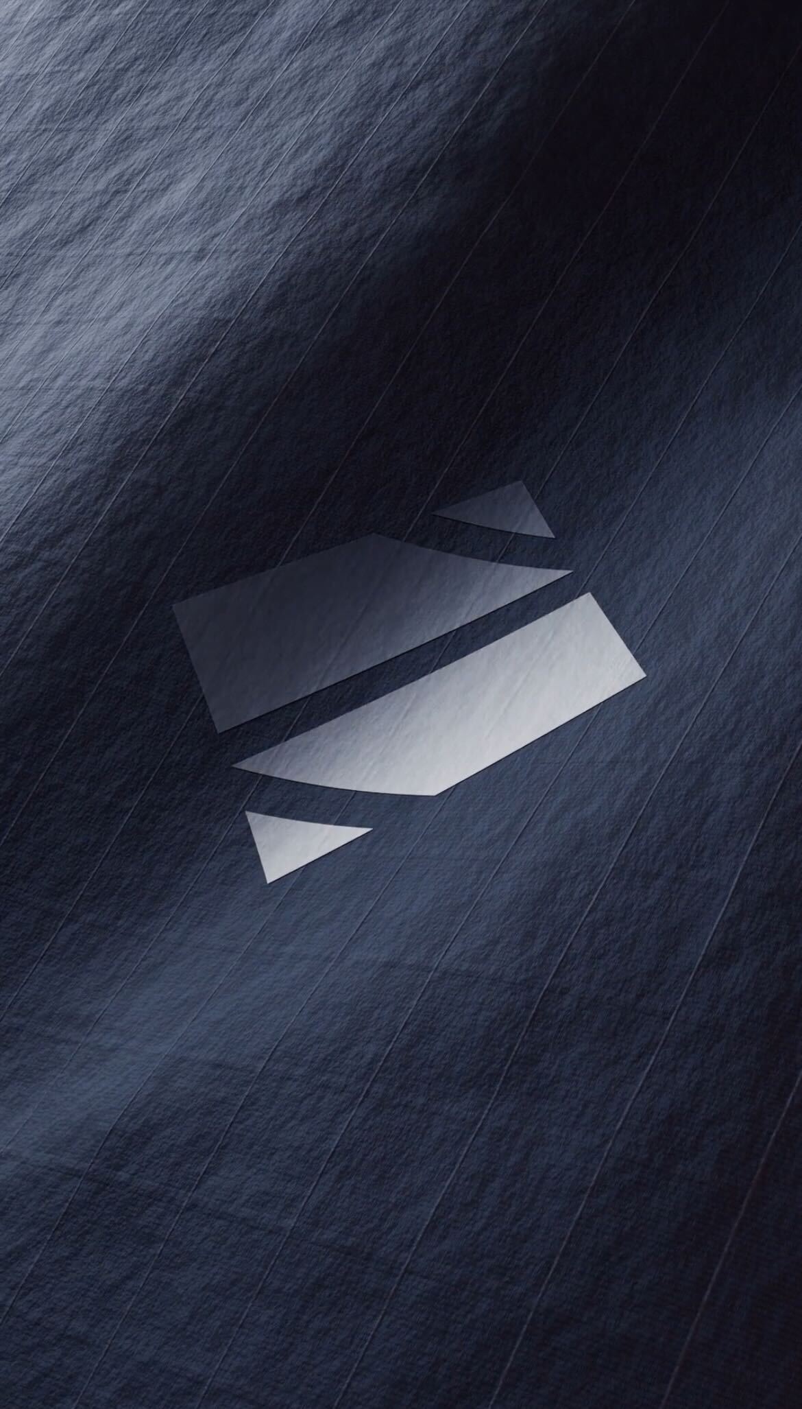 Dark textured surface with a semi-transparent geometric logo consisting of two parallelograms and two triangles in the center.