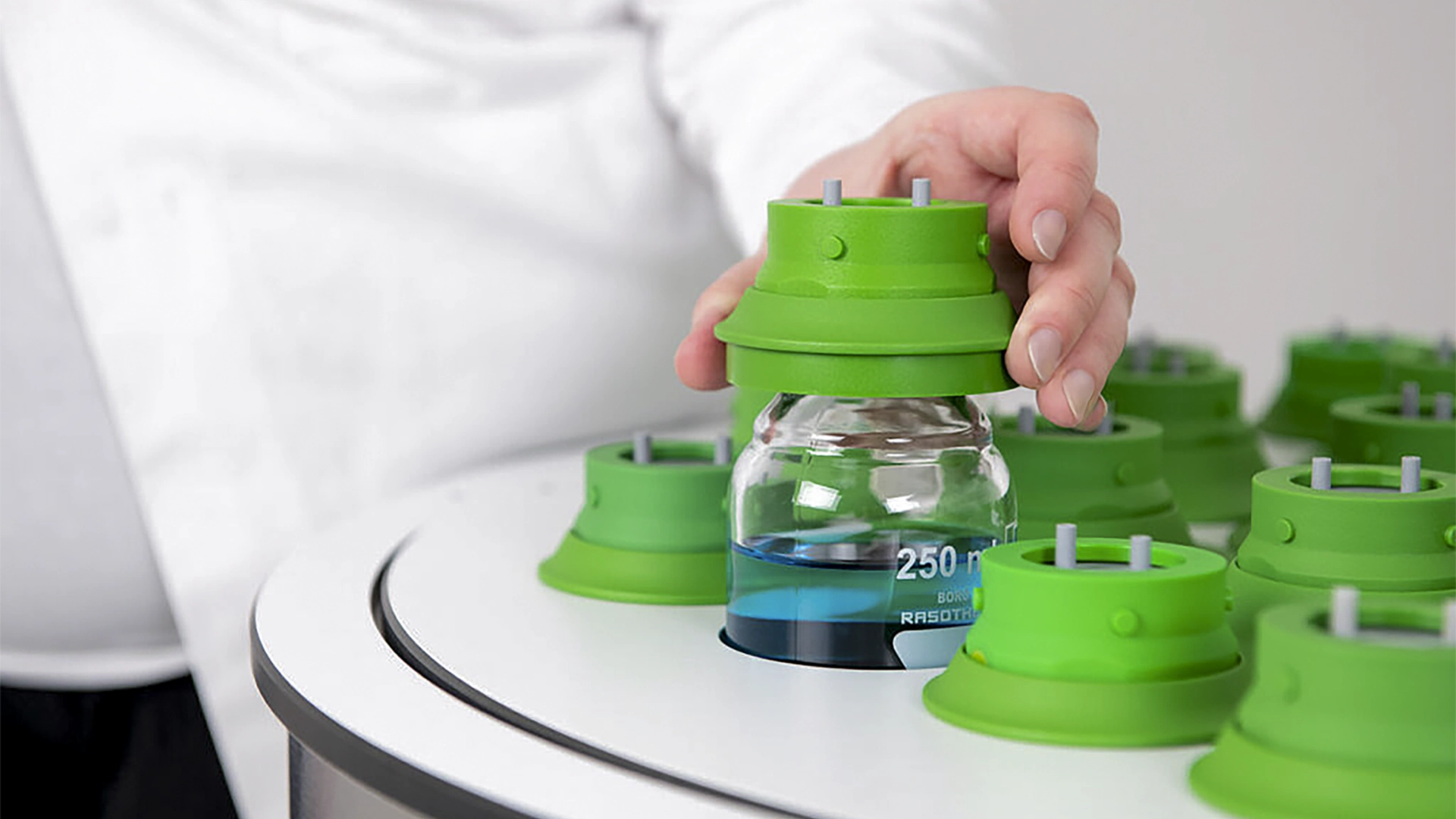 Bioanalyst retrieving a glass bottle from the BPC Air incubator during laboratory testing.