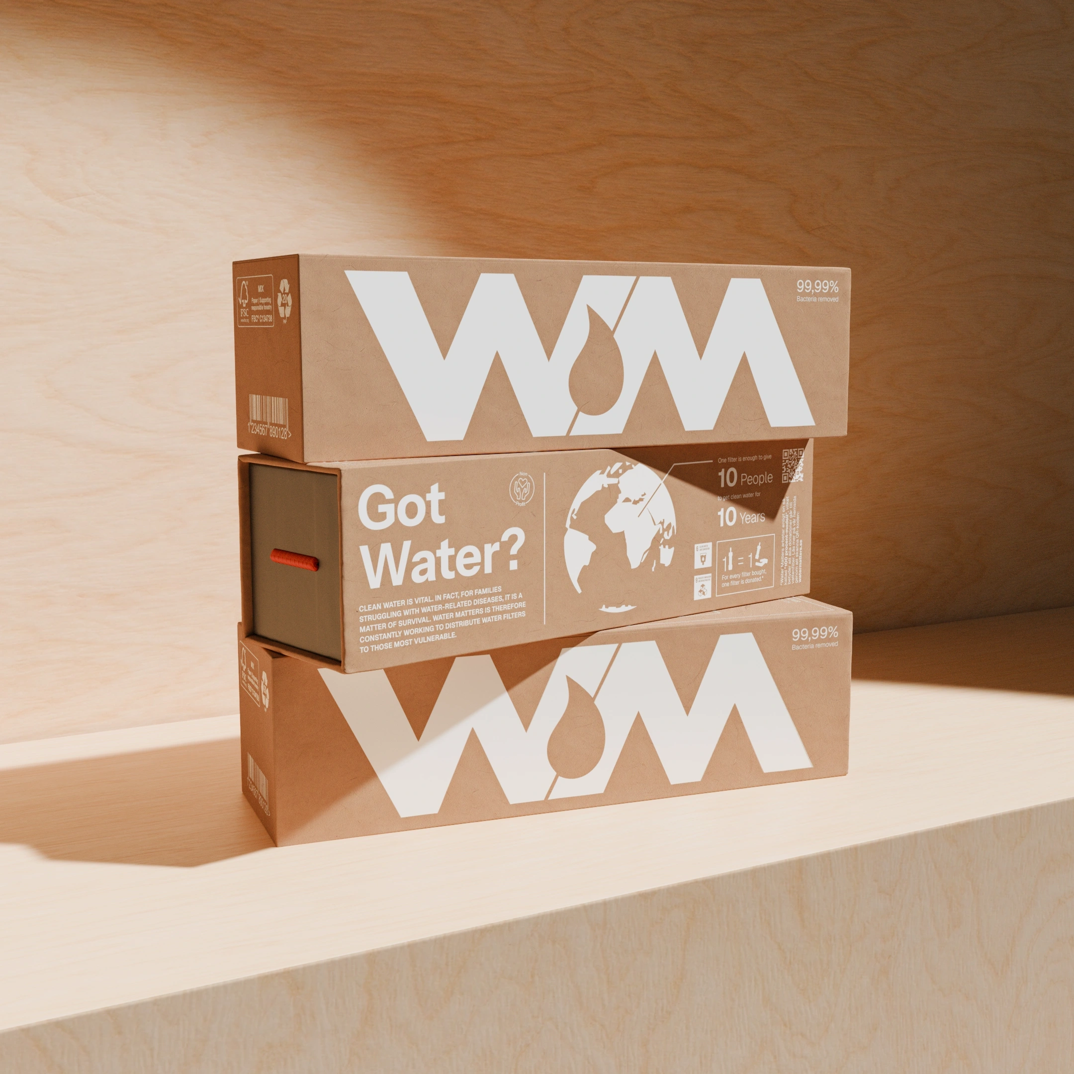 Stack of brown boxes labeled WM with text Got Water? and eco-friendly symbols on a wooden surface.