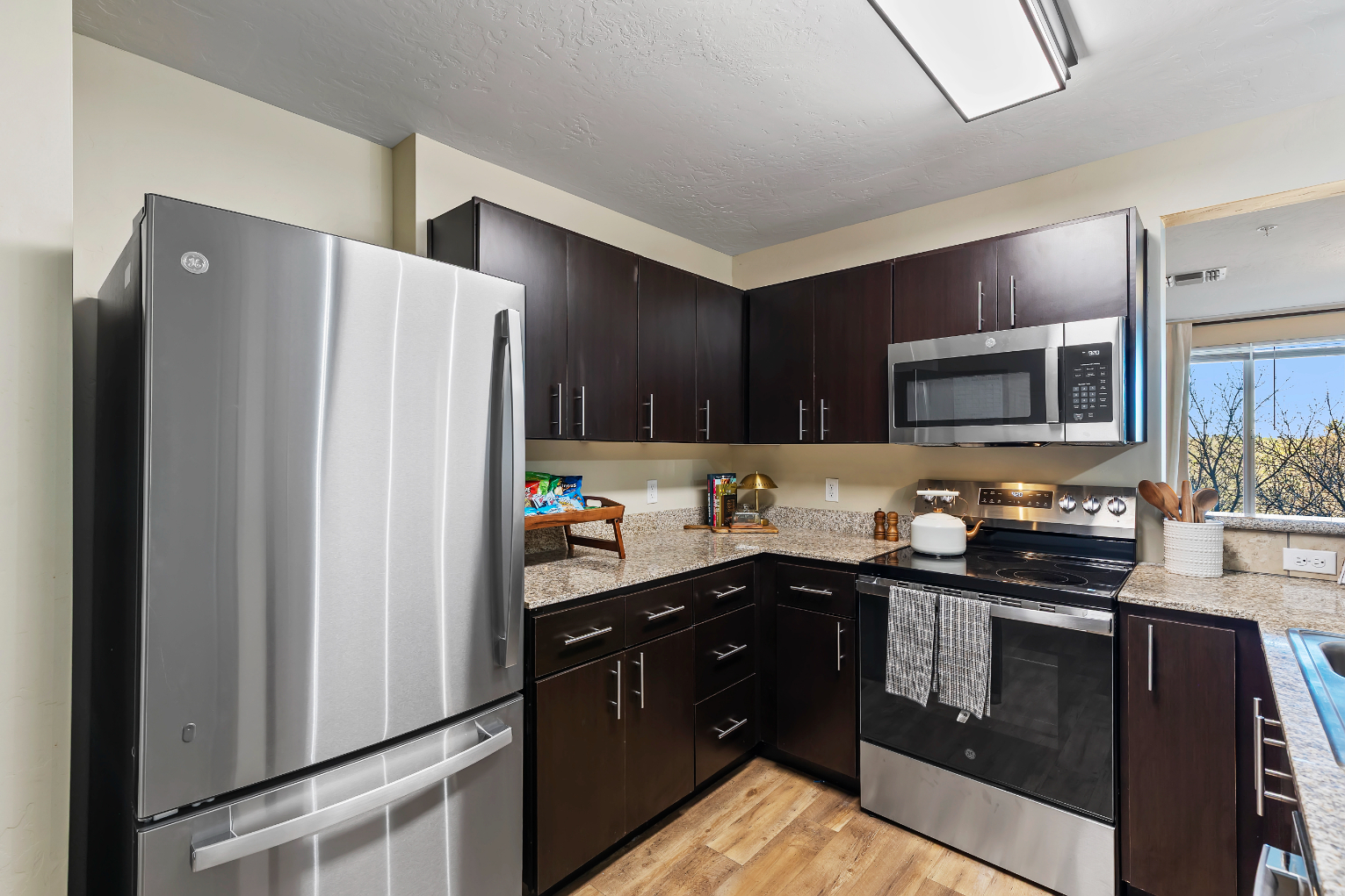 Kitchen wth brown cabinets and stainless steel appliances