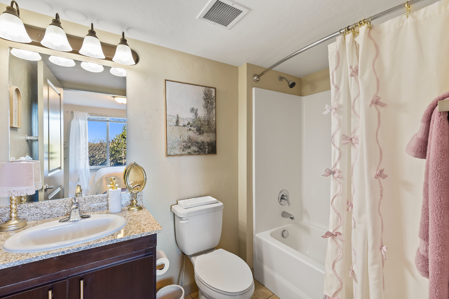 Bathroom with vanity and shower tub combo