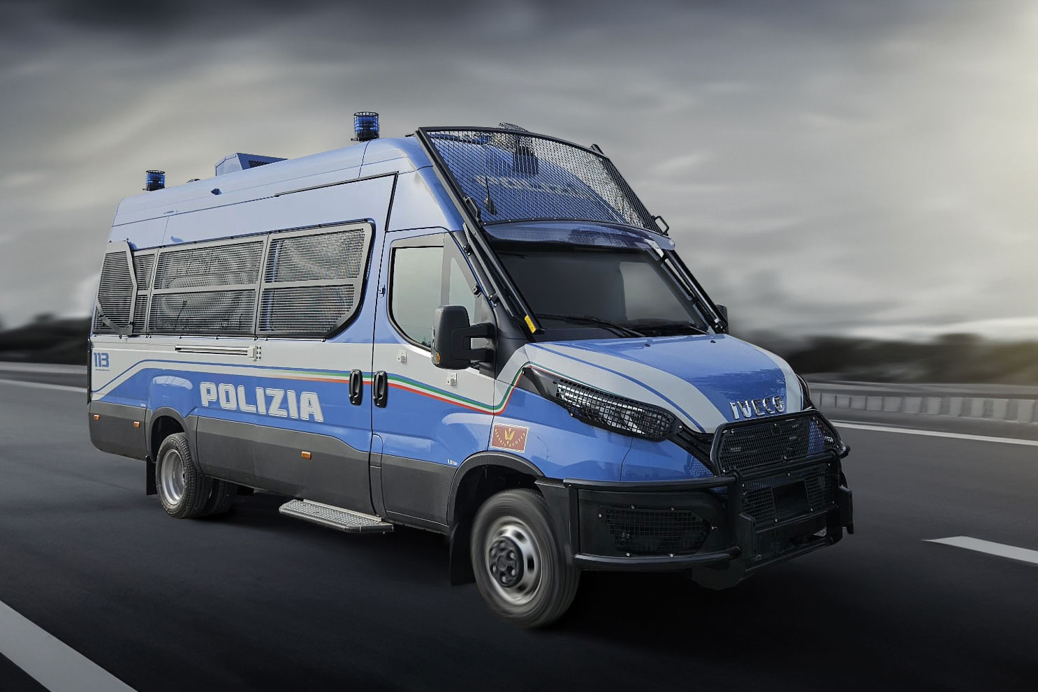 Blue and white Italian police van with protective grills driving on a highway.