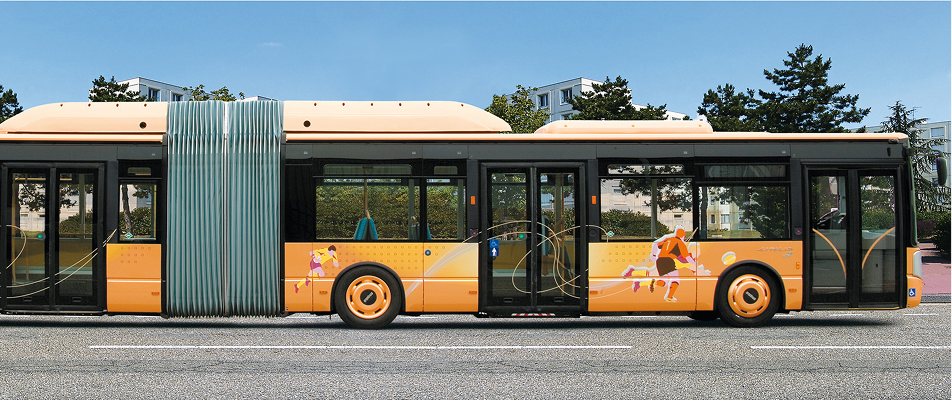 Orange articulated city bus with running figures painted on its side parked on a street.