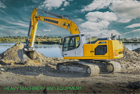 Yellow Liebherr excavator at a lakeside digging earth with cloudy sky in the background.