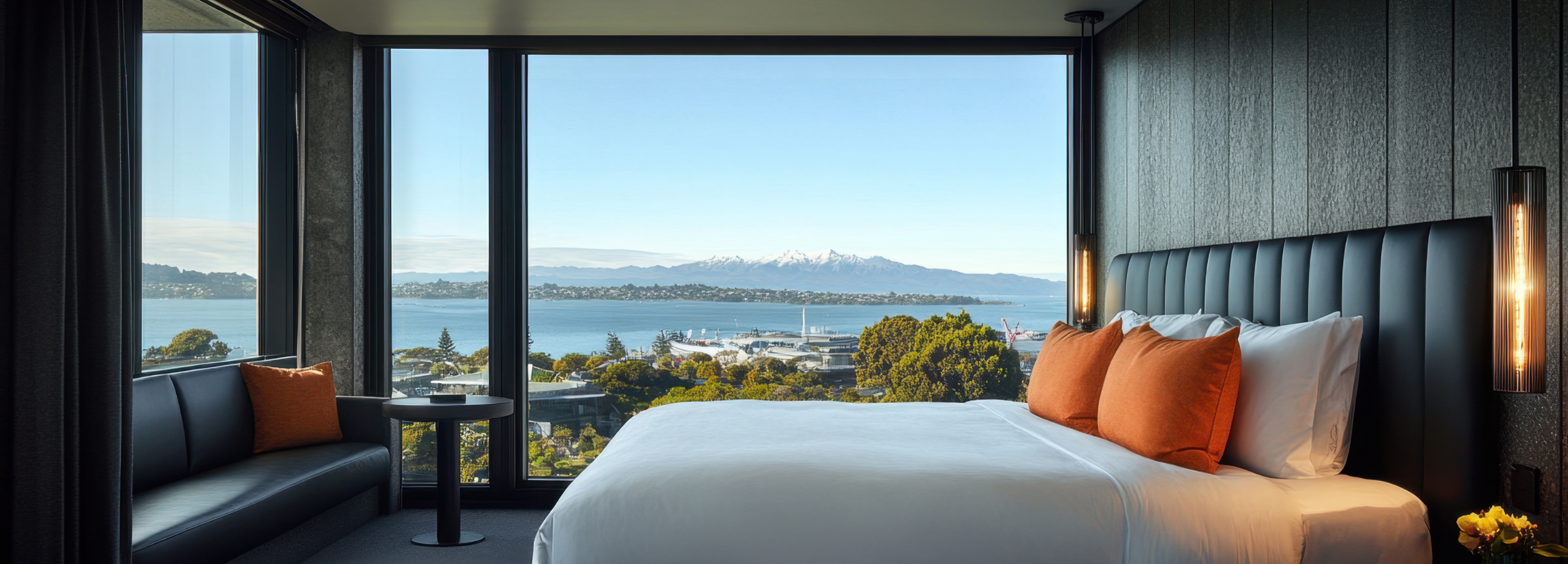 Picture of a hotel bedroom with sea view in the background