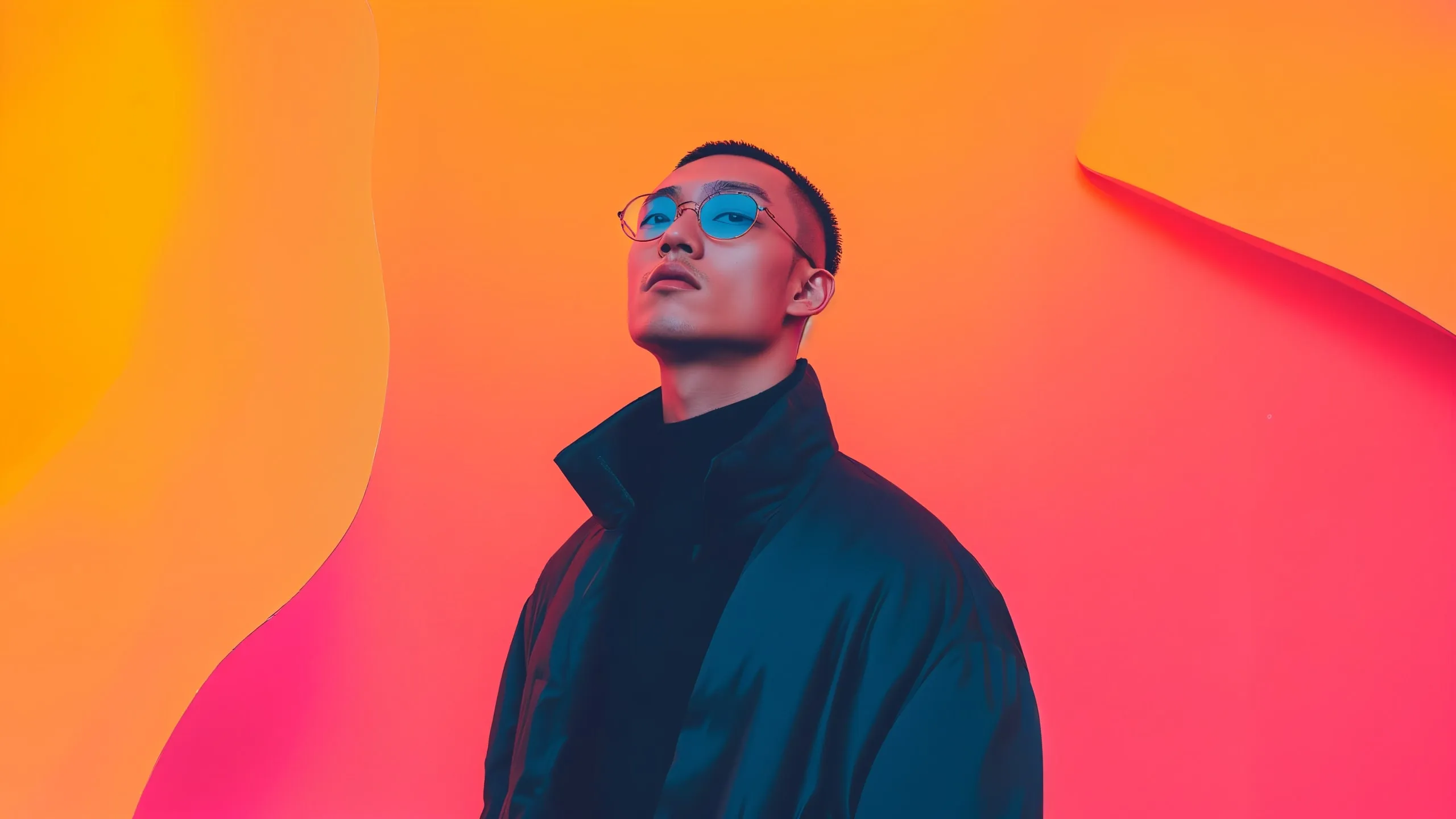 A man wearing a black jacket and sunglasses.